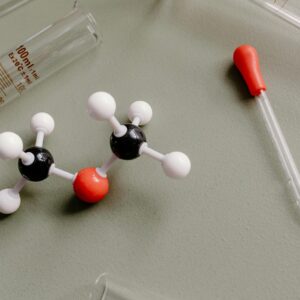 Company Close-up of laboratory equipment and molecular model on a flat surface.